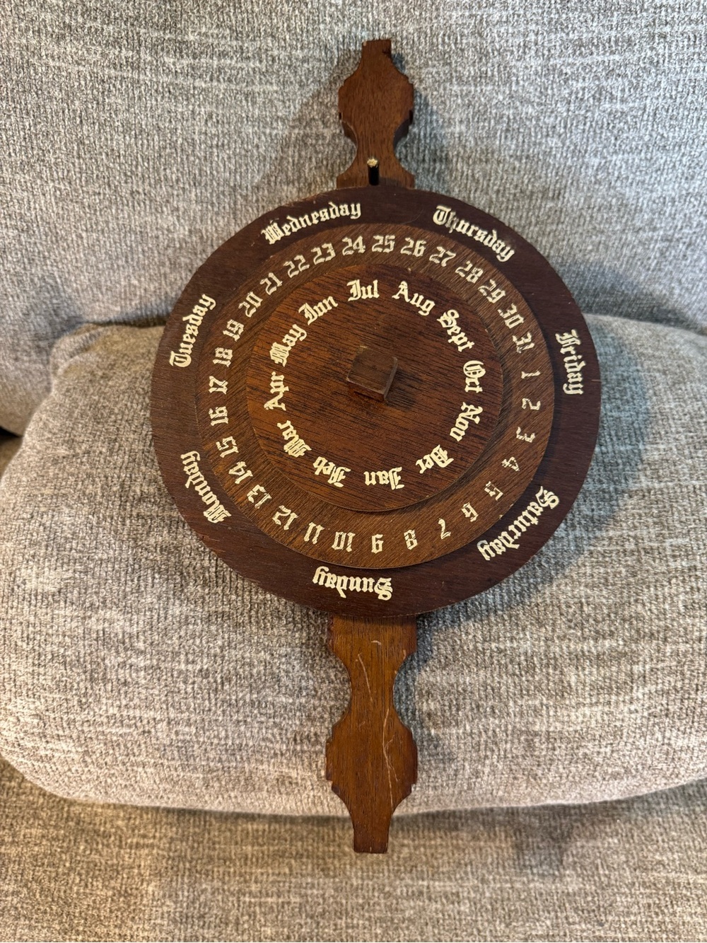 Vintage wooden perpetual calendar display date by rotating its concentric wheels